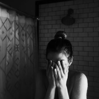 Mother crying in the shower