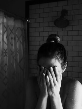 Mother crying in the shower